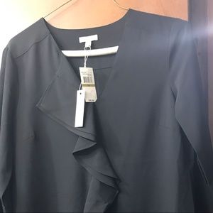 Black dress with ruffled front and round hem